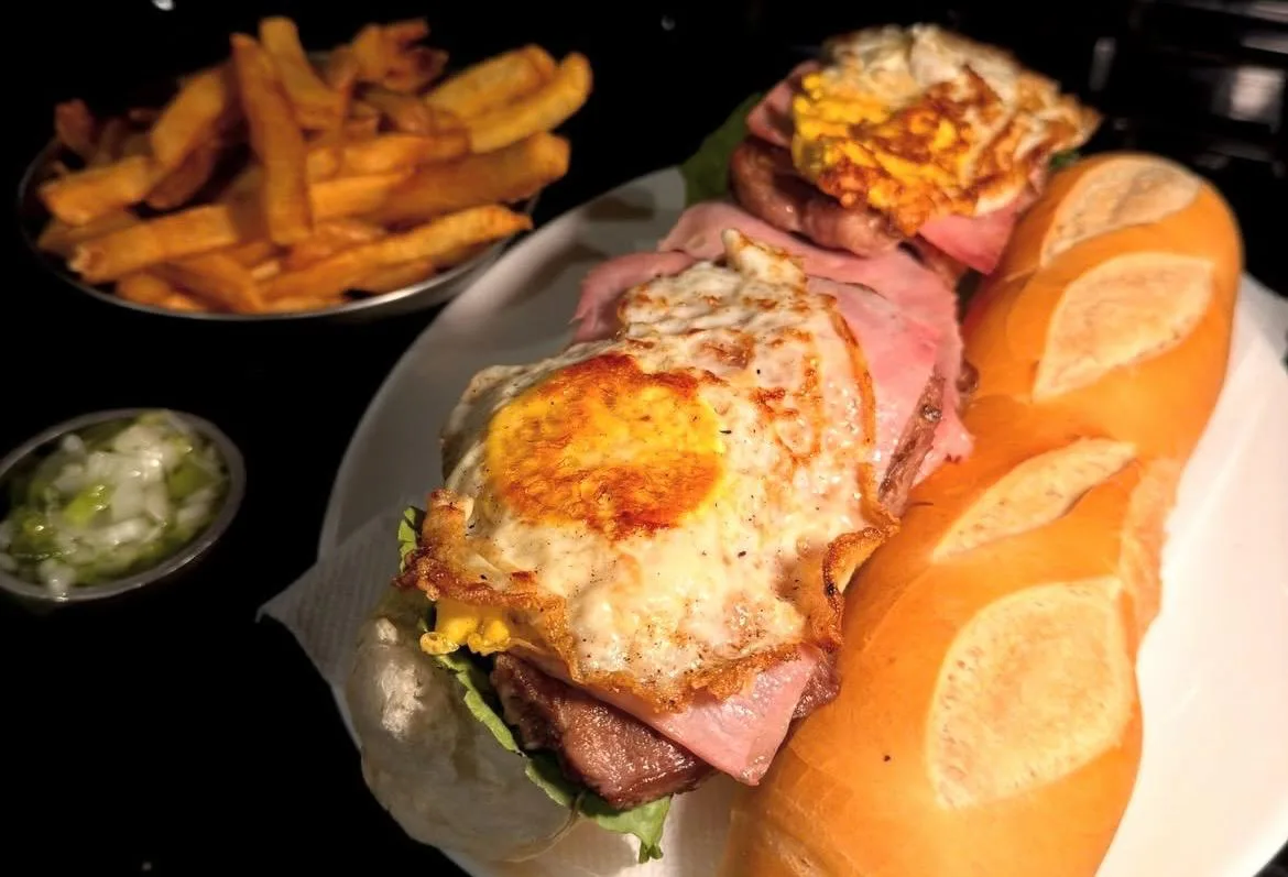 Sándwich de lomito con jamón, huevo frito y papas fritas